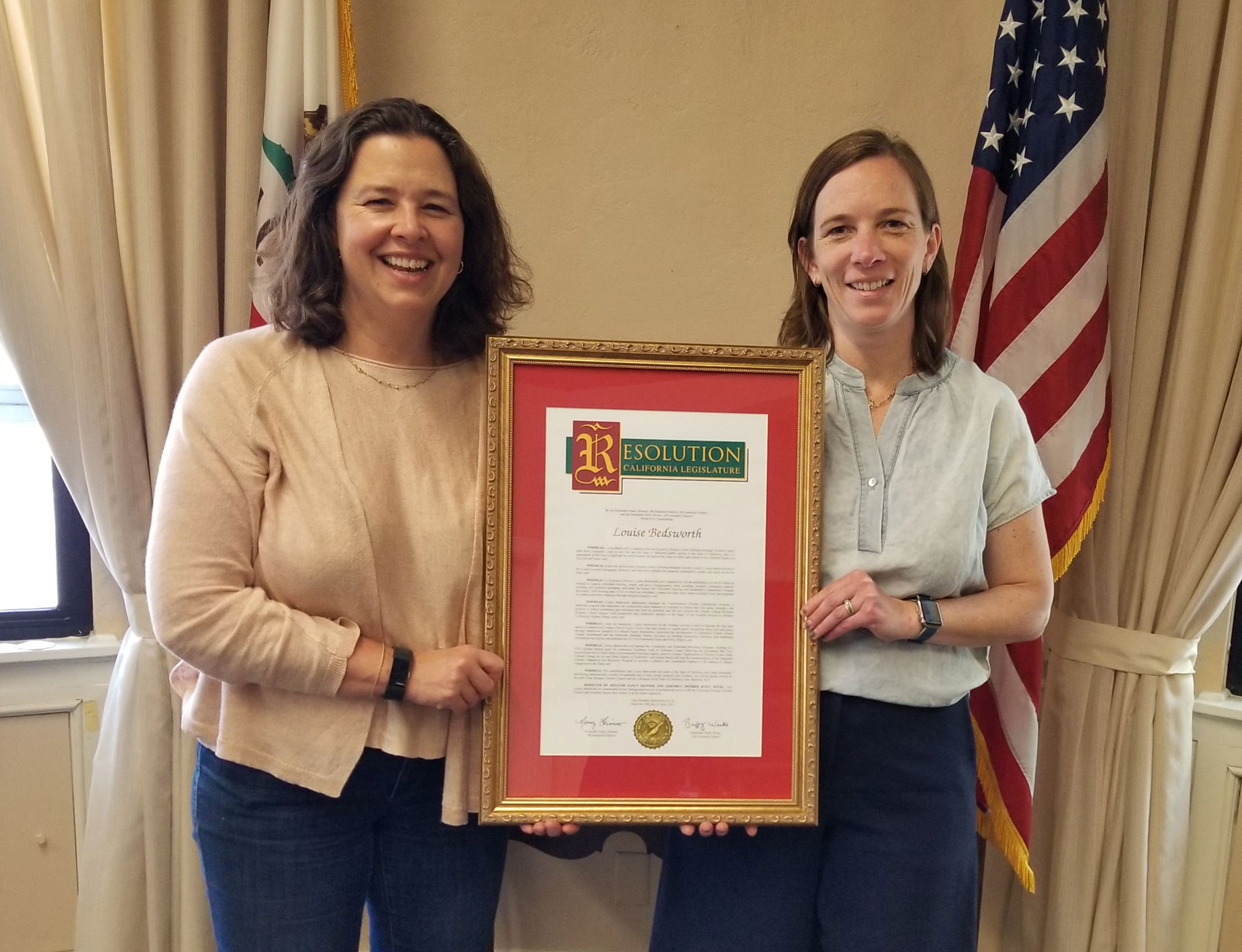 Photo of Kate Gordon and Louise Bedsworth holding a resolution