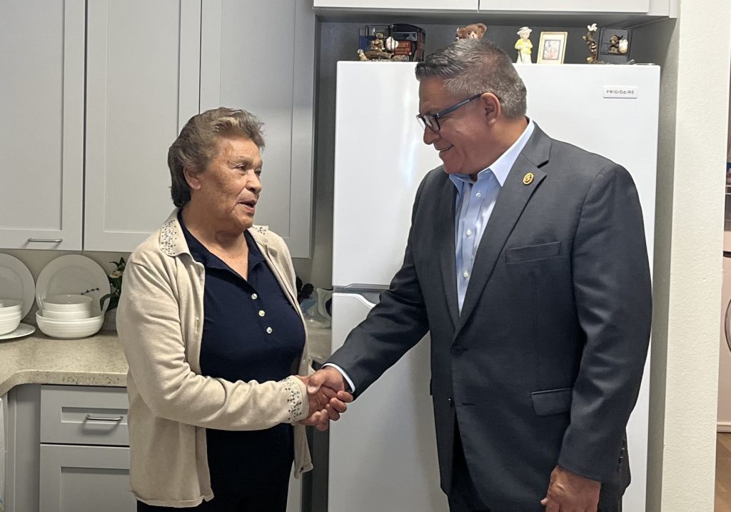 Anita shaking hands with Calif. Representative Salud O. Carbajal.