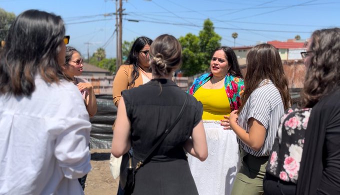 A photo of people outdoors in a group talking
