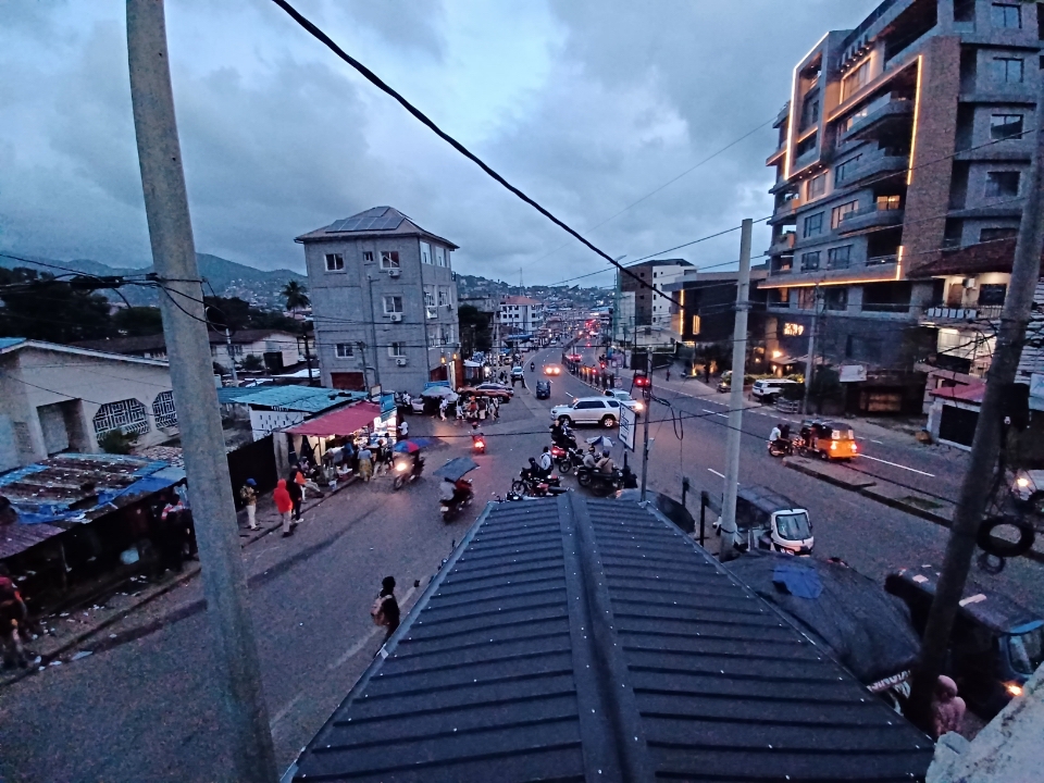 A photo of buildings and a street in the City of Freetown near downtown. 