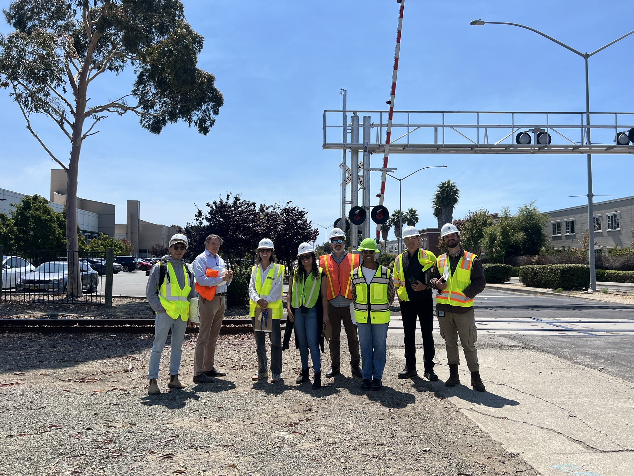 A group of people dressed in hard hats and reflective vests