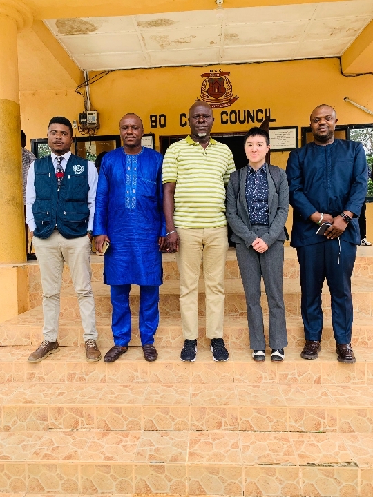A photo of five people, including the Mayor of Bo and SGC’s Dr. Hoi-Fei Mok.