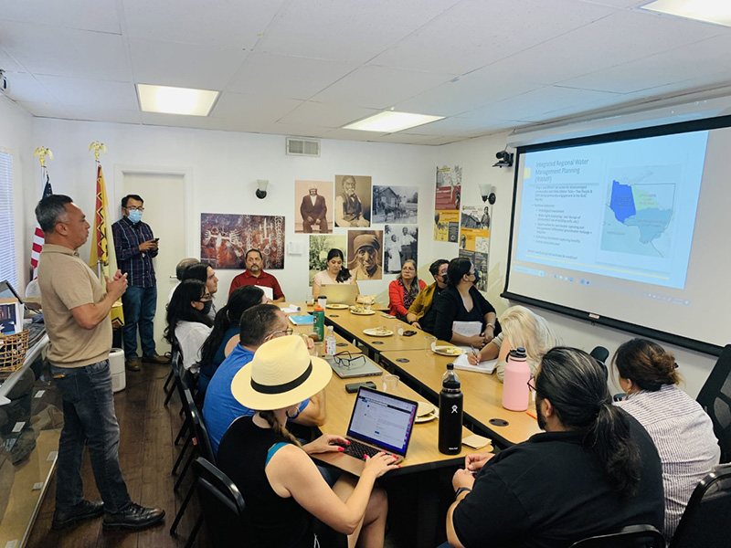 A group of people looking at a project map at a workshop.